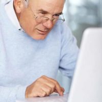 Elderly man using internet